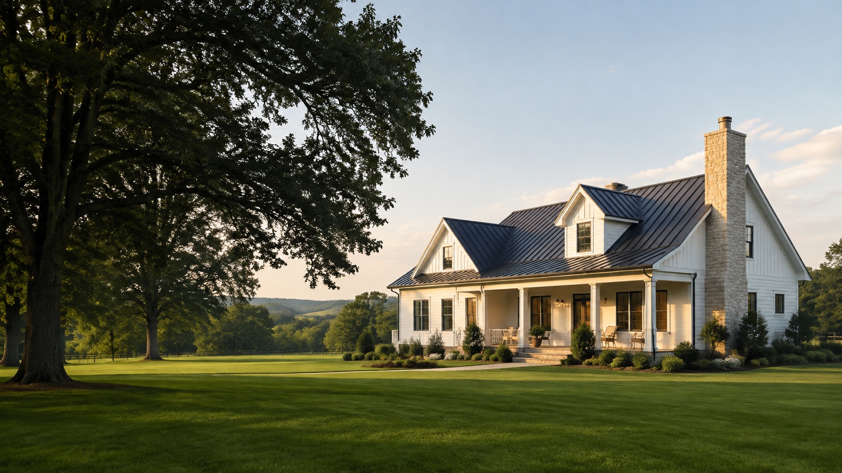 A white country home with a stone chimney on expansive green acreage